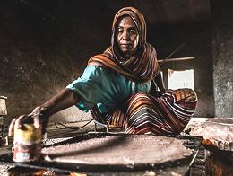 Woman baking Kisra Bread