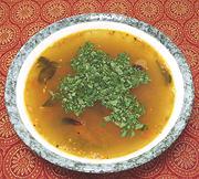 Bowl of Rasam witn Lemon